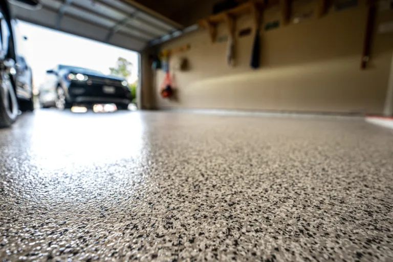 garage floor with car in background speckled epoxy flooring in the foreground