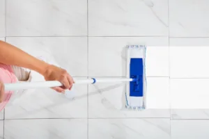 High Angle View Of Person Cleaning tile Floor With Mop