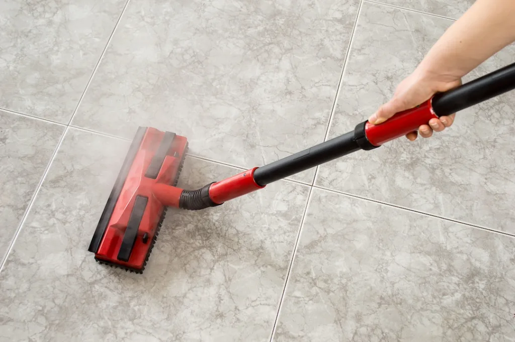 woman cleaning floor steam cleaning into the room